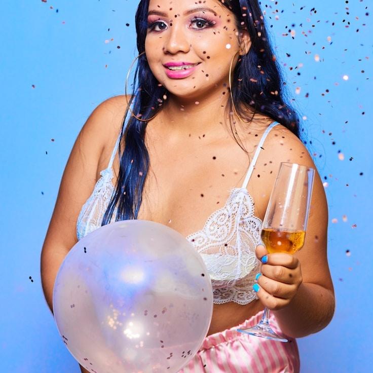 Kaveri Mehta, Lead Design Curator at OrchardLineHub, reviewing corporate floral arrangements